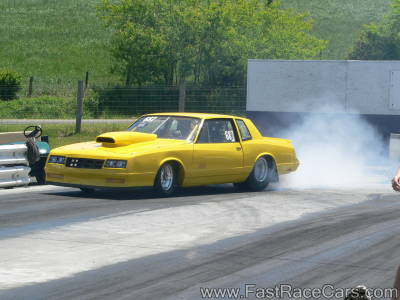 Yellow Monte Carlo Drag Car Doing Burnout