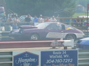 Purple And White Monza Drag Car Popping A Wheelie